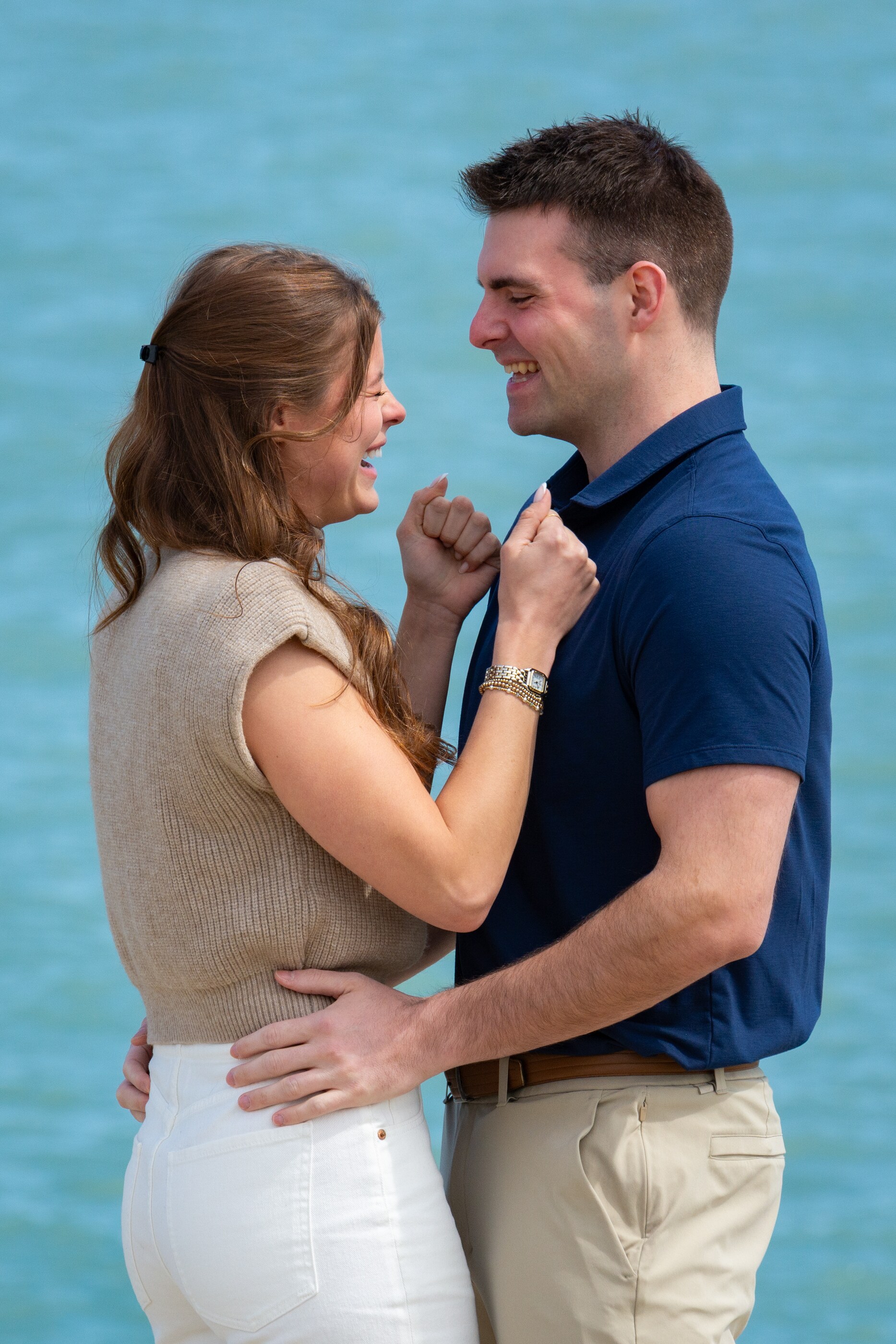 Tom and Anna laughing by the water