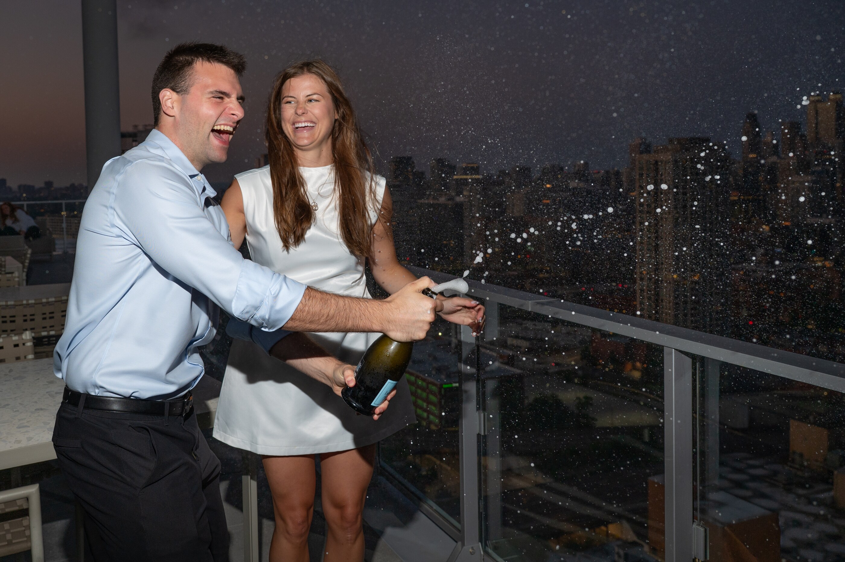 Tom and Anna on a rooftop at dusk