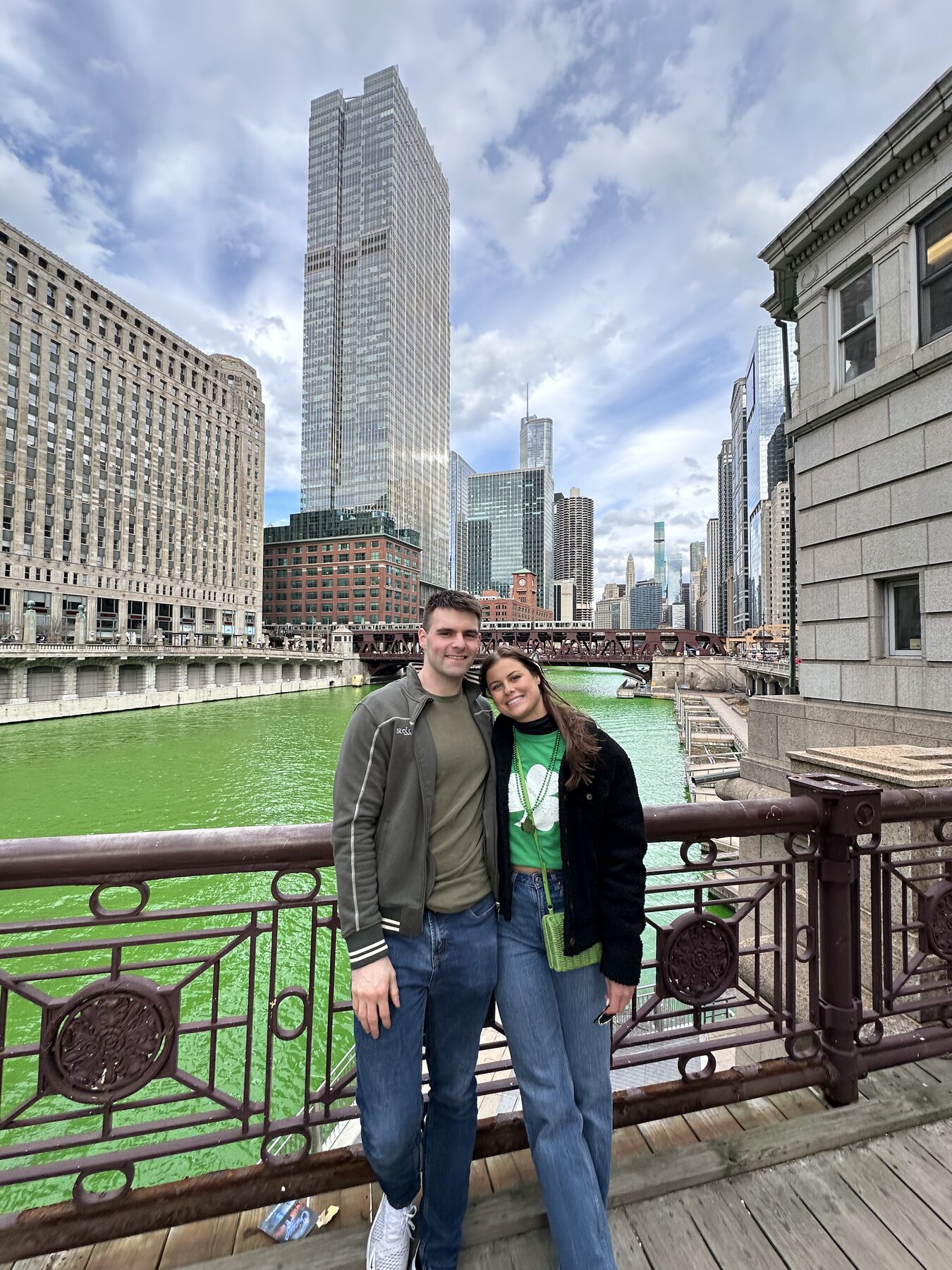 Tom and Anna on a bridge over the green Chicago River on St. Patrick’s Day